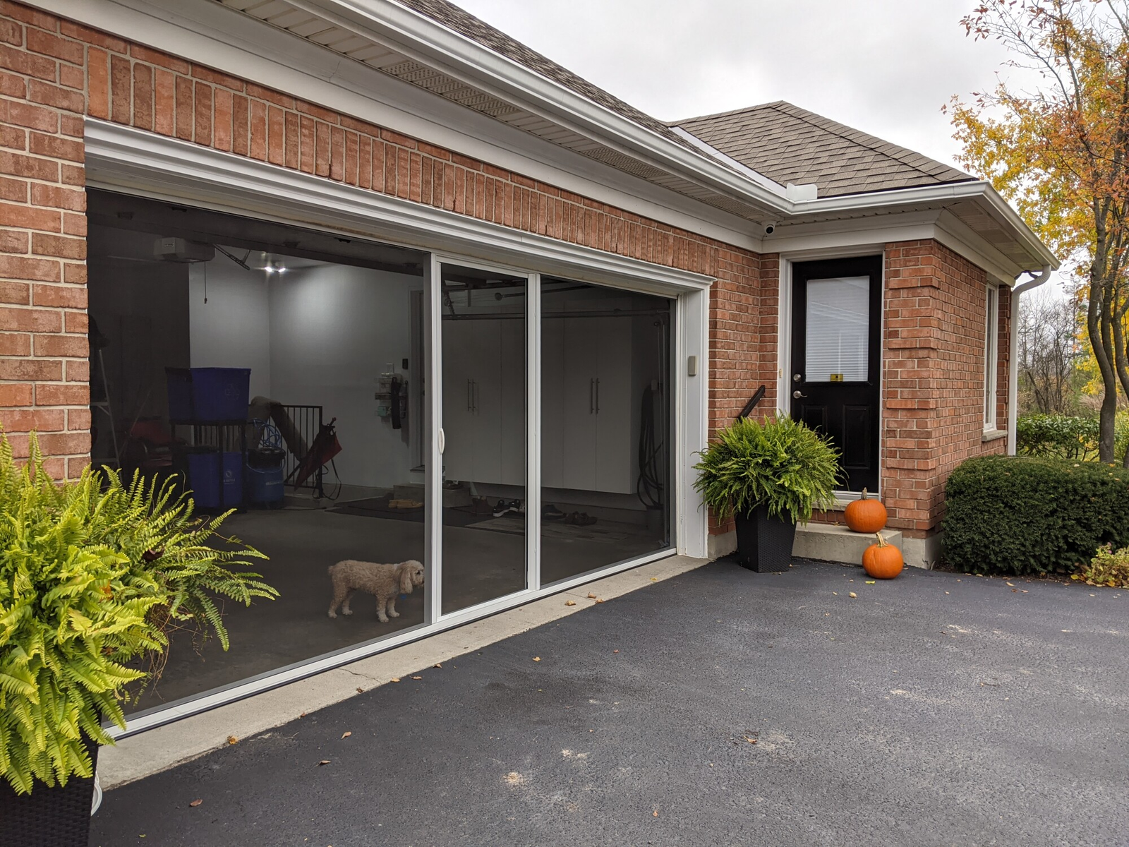 Kenmore garage with a newly installed retractable garage door screen, enhancing ventilation and usability.